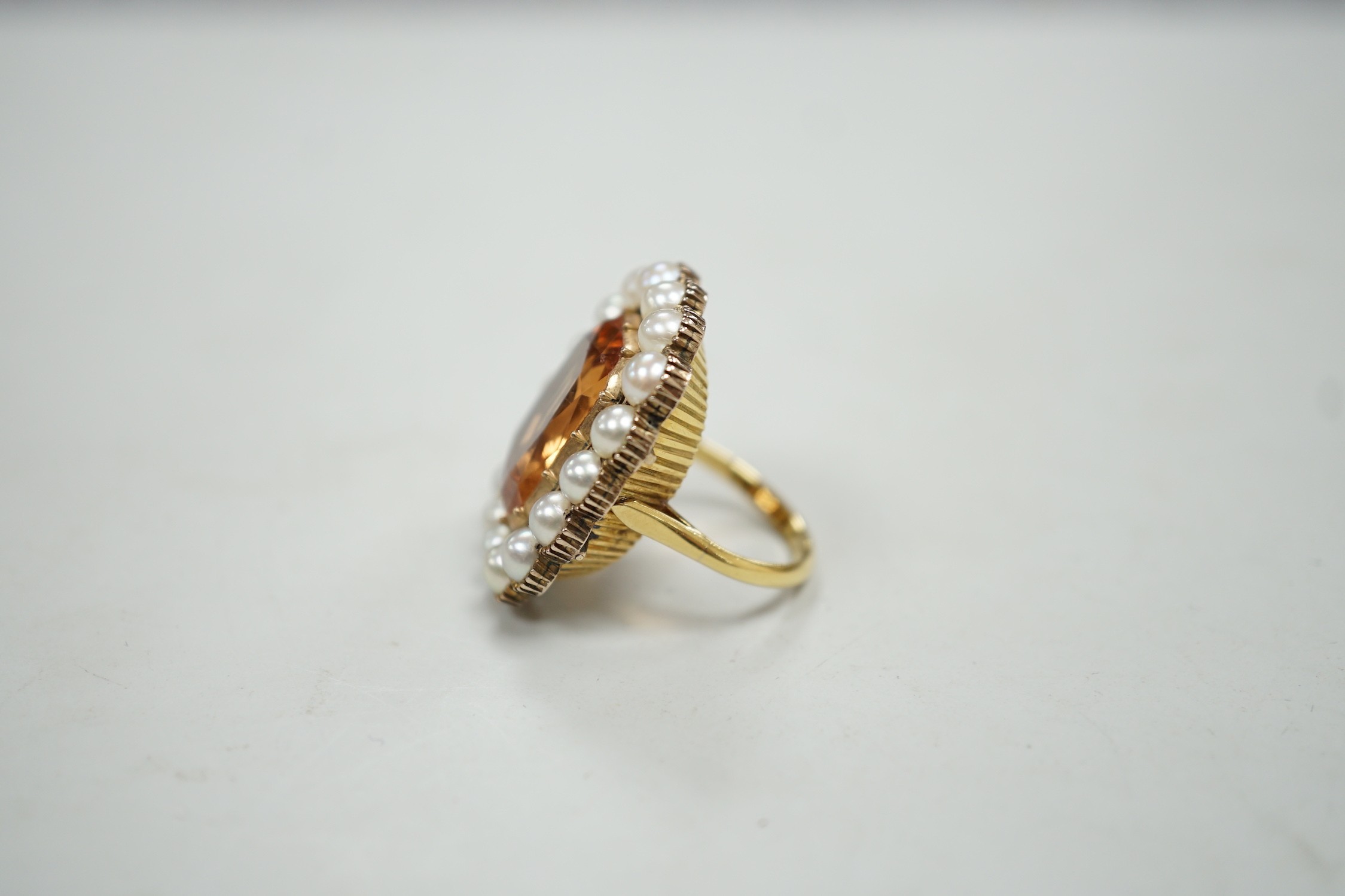 A mid 20th century gold, orange topaz and split pearl set cluster ring (adapted from an earlier brooch), size M/N, gross weight 15.7 grams.